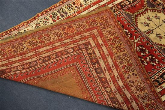 A Ghiordes red ground prayer rug, West Anatolia, 5ft 6in by 3ft 10in.